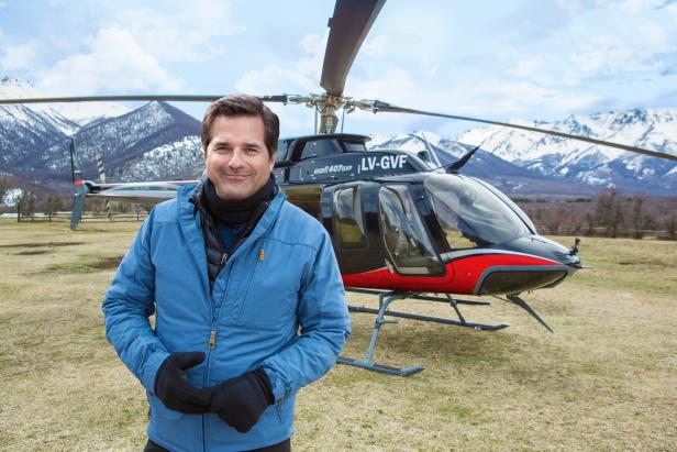 BAGUALES, PATAGONIA, ARGENTINA -SEPTEMBER 11 2017: Host Don Wildman pauses next to his helicopter as he examins the October 1972 crash of the plane carrying an Uruguayan Rugby team in the Andes mountains during the filming of "Mysteries at the Museum Special: ALIVE". After a visit to the Andes Tragedy and Miracle Museum in Montevideo, Uruguay, Don Wildman learns firsthand what it took for the crash's sixteen survivors to overcome avalanches, sub-zero temperatures, and lack of food at 12.000 feet, and the devastating news that the search for them had been called off, as described in survivor Nando Parrado's book "Miracle in the Andes" (photo Gilles Mingasson for The Travel Channel).